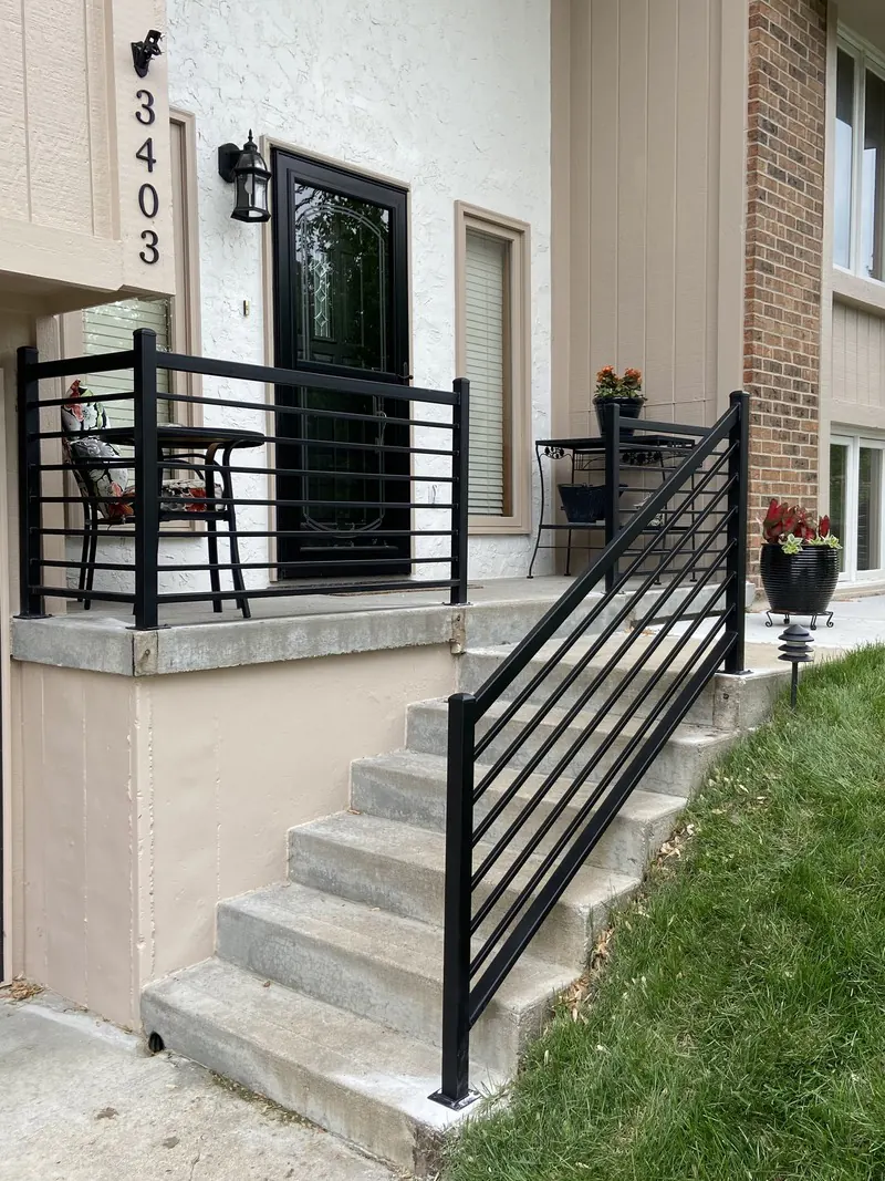 Black porch stair railing, welding job by KC Ironcore