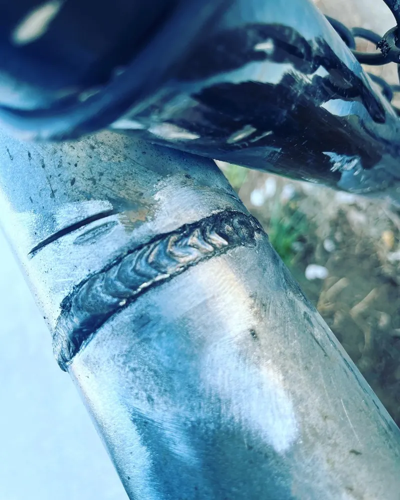 Repair weld on a galvanized fence post, welding job by KC Ironcore