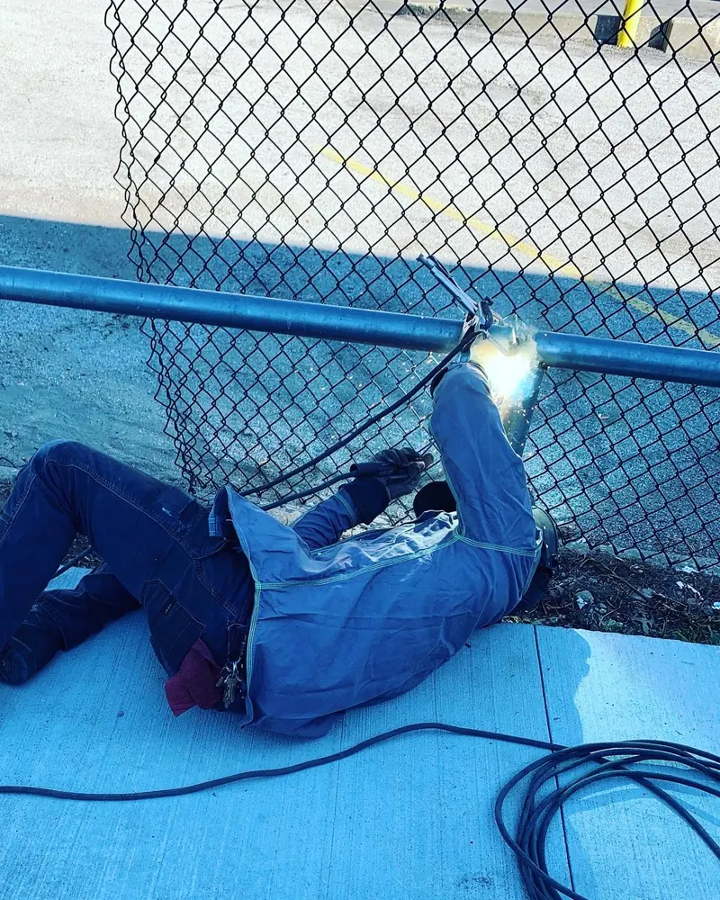 On-site chain-link fence rail repair, welding job by KC Ironcore