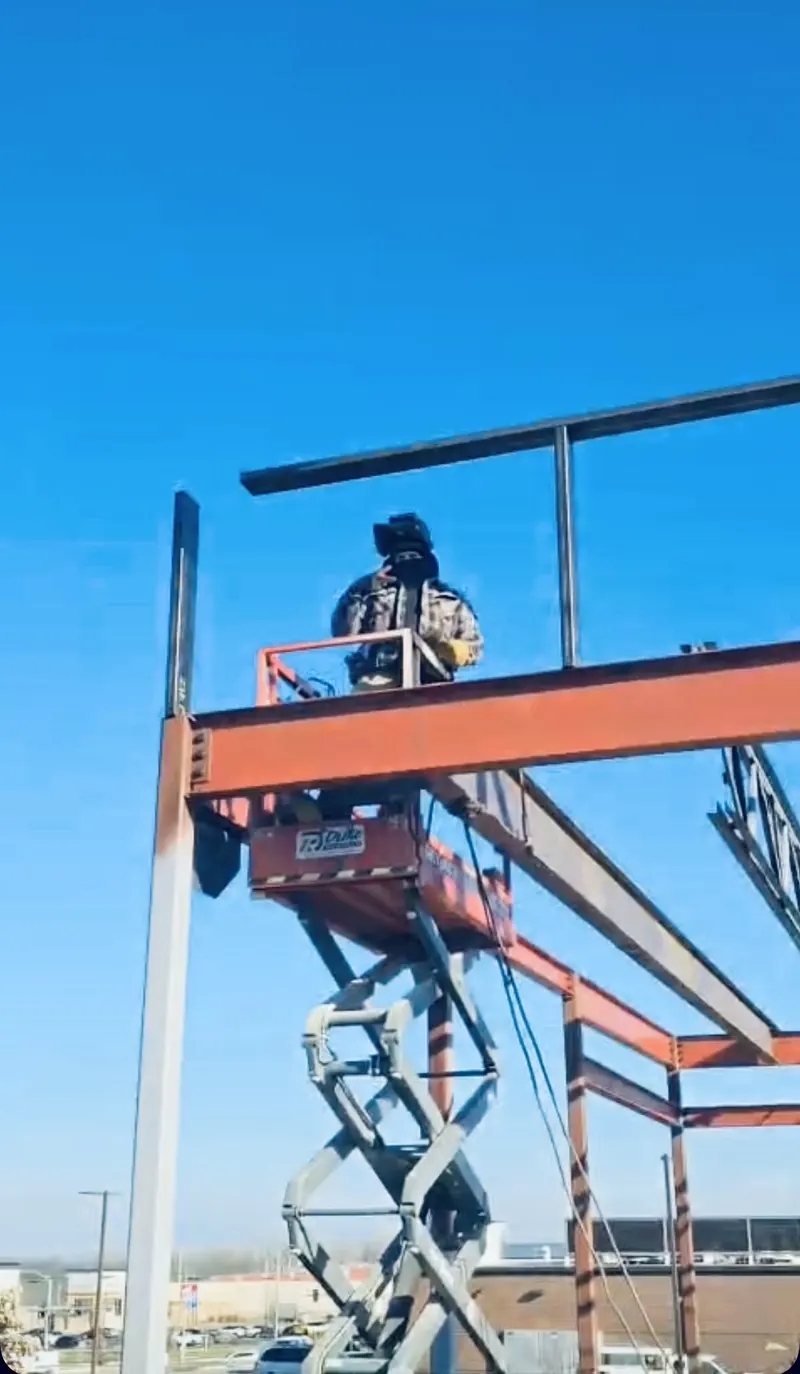Setting structural steel from a scissor lift, welding job by KC Ironcore