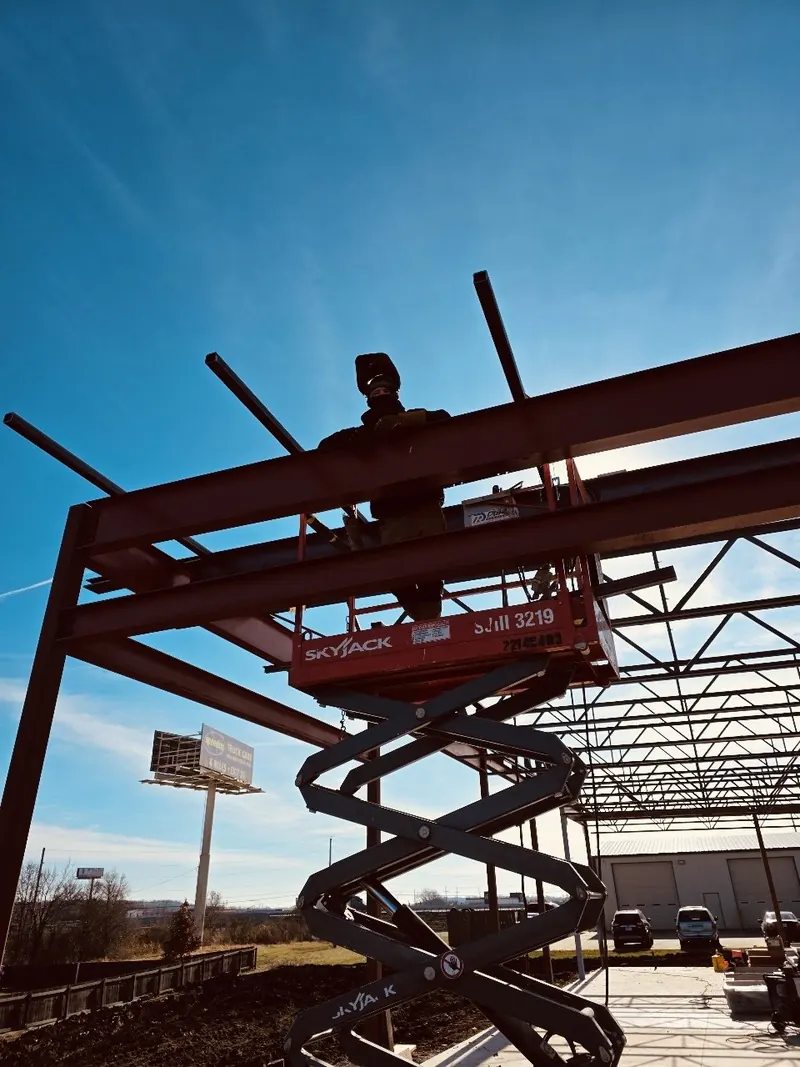 Welding roof beams on a new steel building, welding job by KC Ironcore
